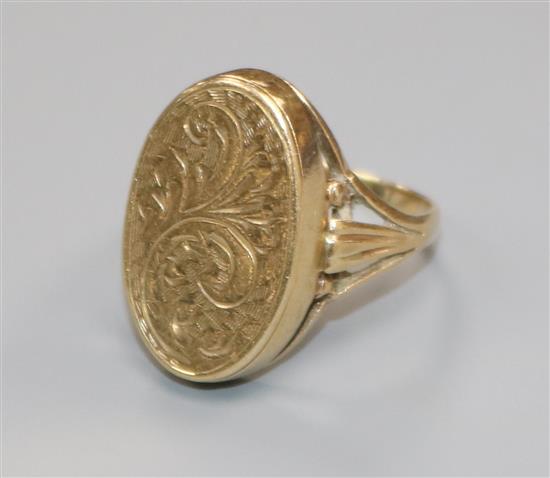 An engraved 9ct gold oval locket ring, size N.